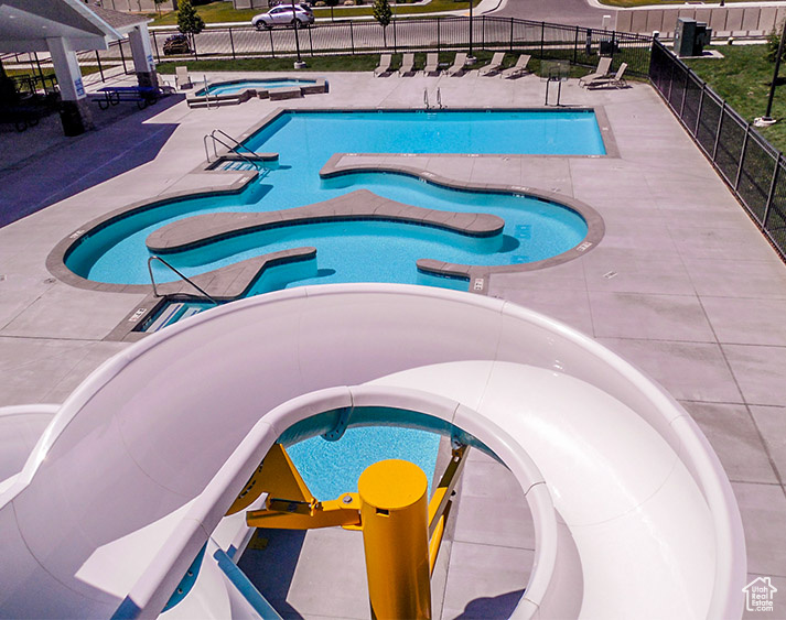 View of swimming pool with a community hot tub