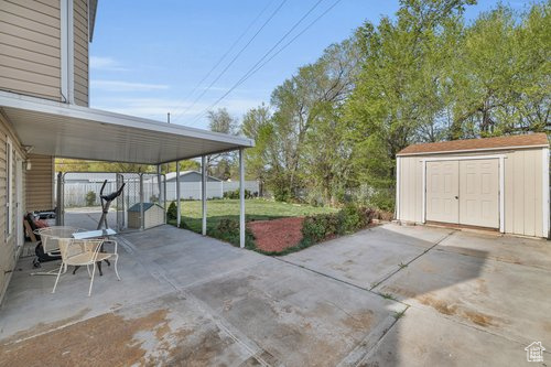 View of terrace with a storage shed and a carport