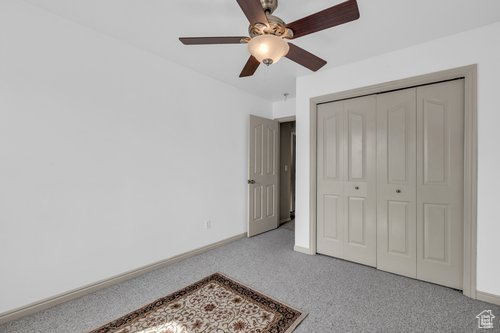 Bedroom featuring a closet, carpet floors, and ceiling fan