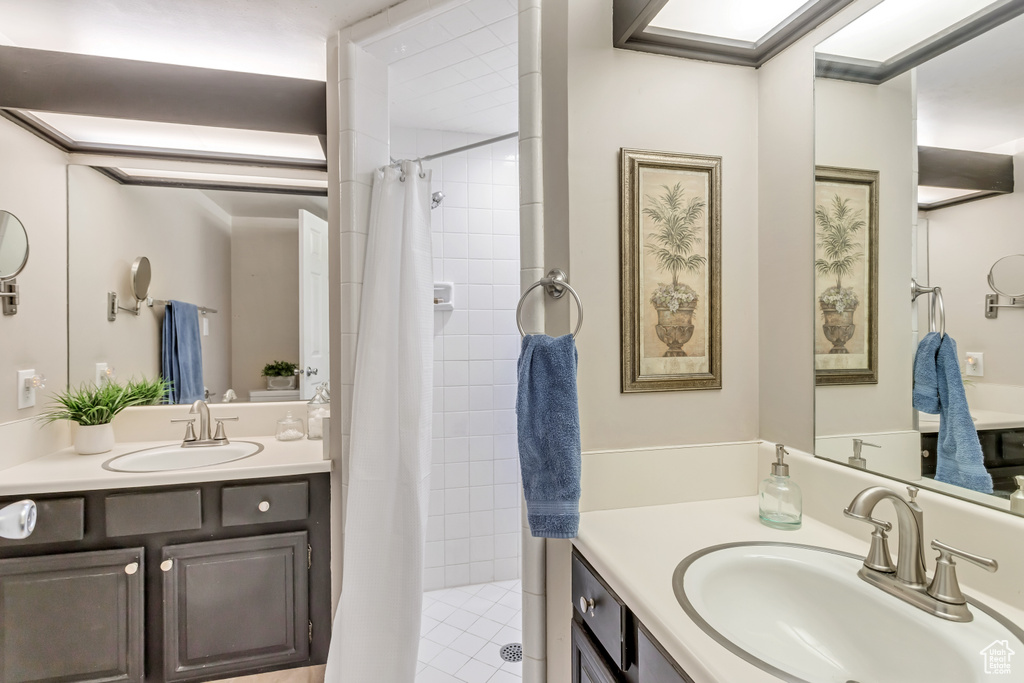 Bathroom with vanity and a shower with shower curtain