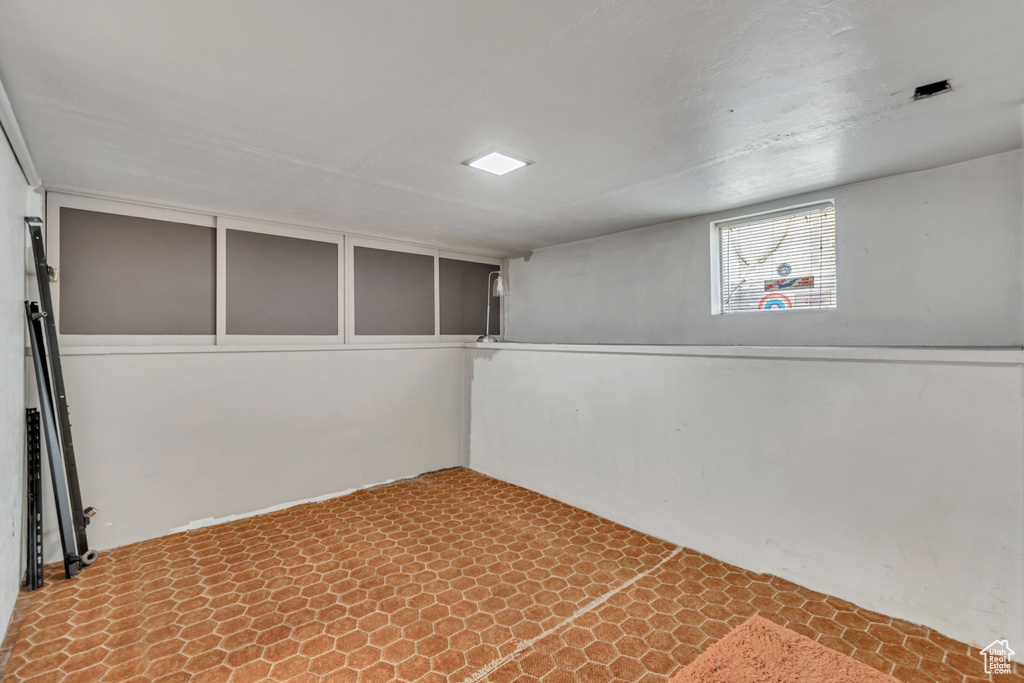 Basement featuring light tile floors