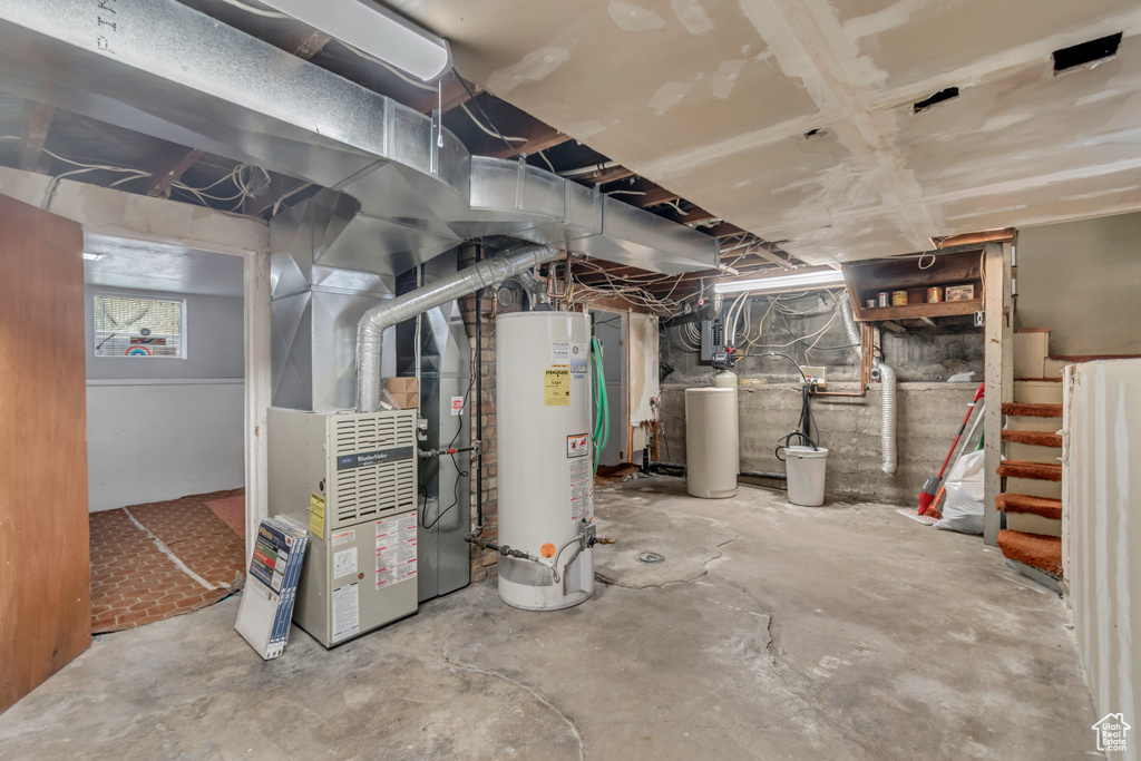 Basement featuring water heater and heating utilities