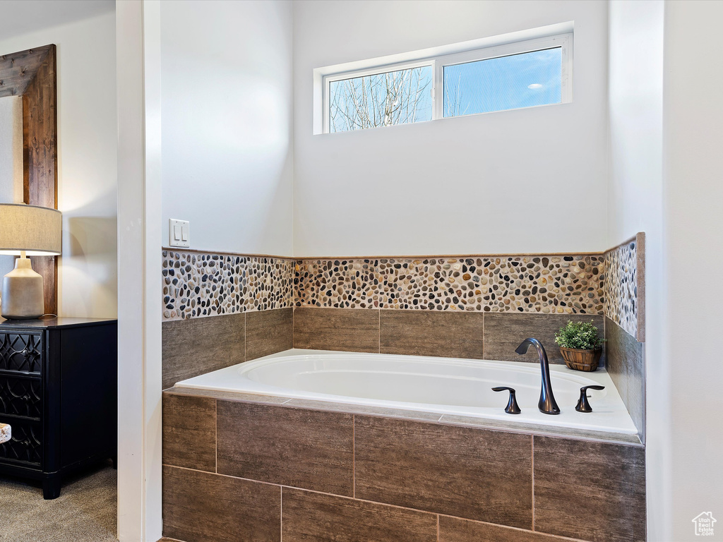 Bathroom featuring a relaxing tiled bath