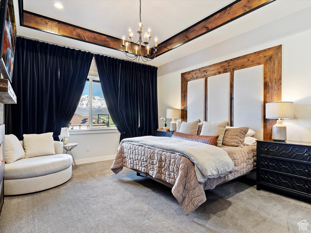 Carpeted bedroom with a mountain view and a chandelier