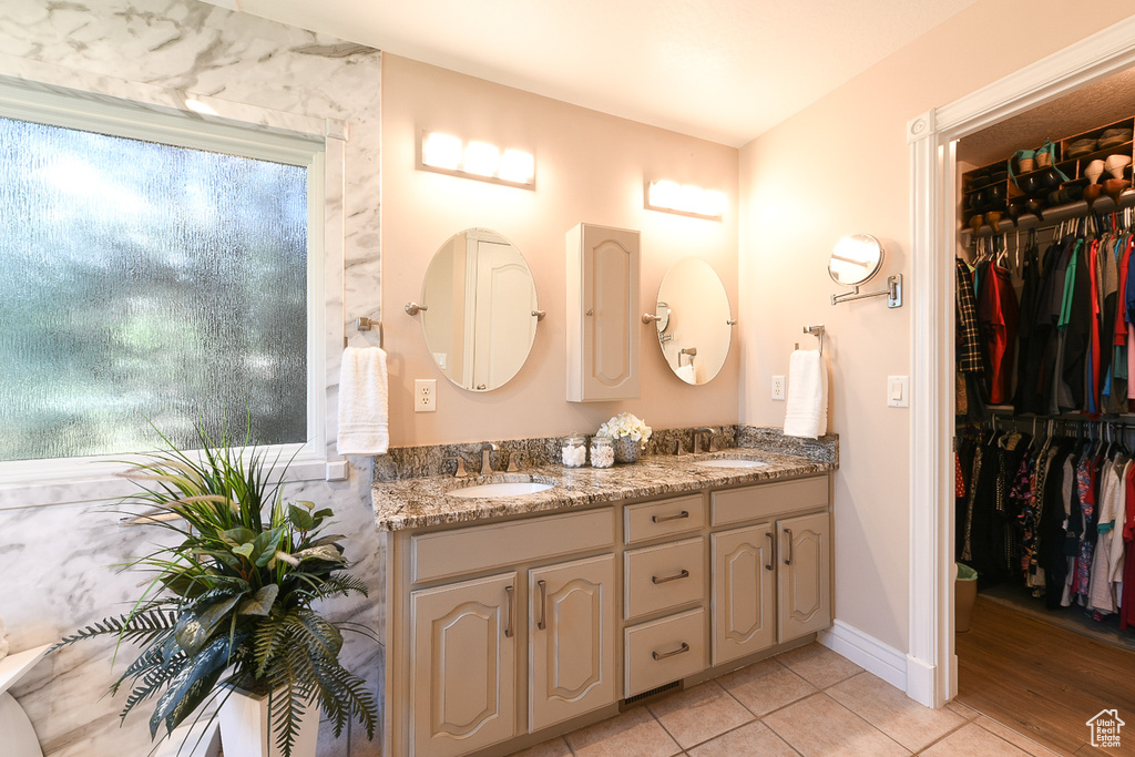 Bathroom featuring hardwood / wood-style flooring and double sink vanity