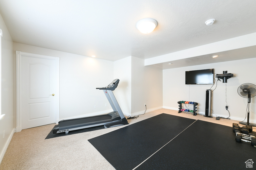 Workout area featuring light carpet