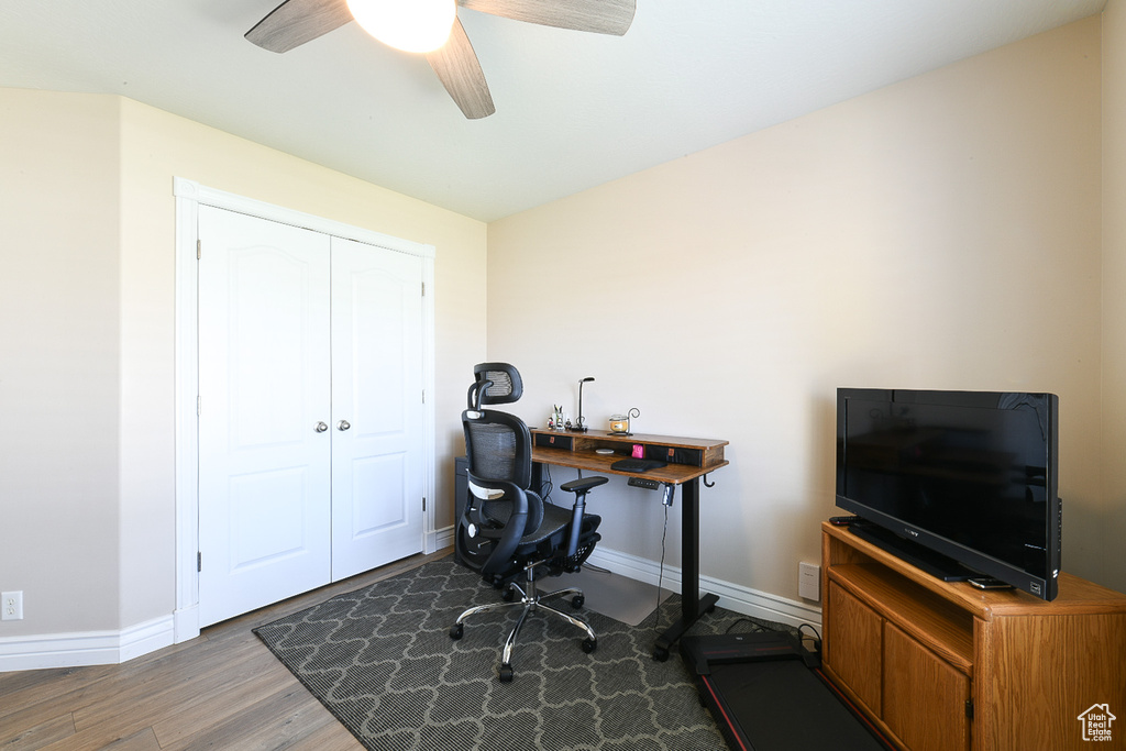 Office with ceiling fan and hardwood / wood-style flooring