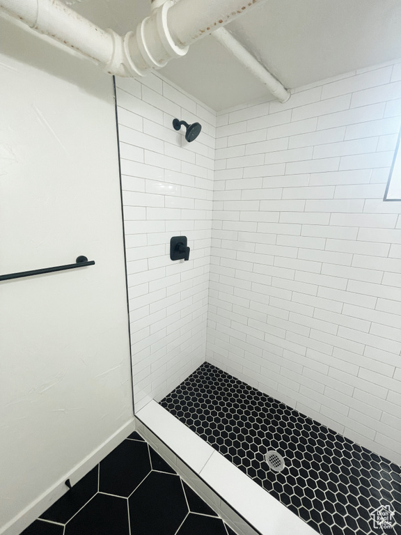 Bathroom featuring tile floors and a tile shower