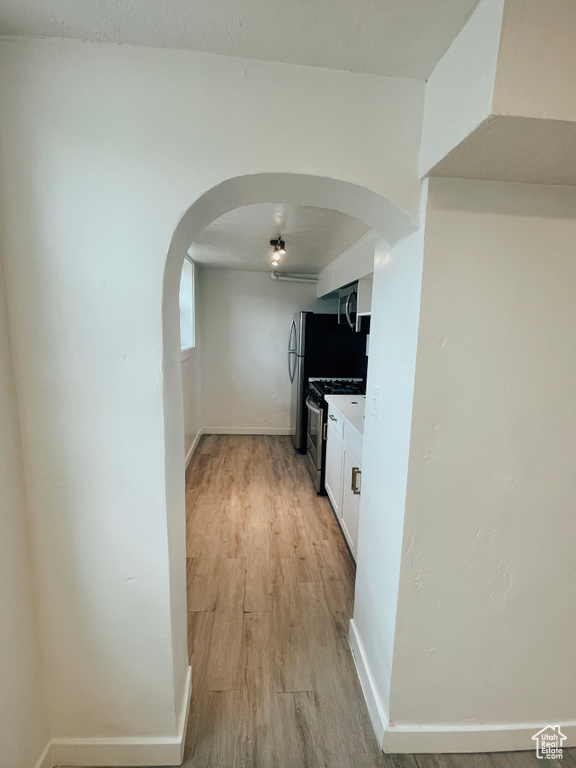 Corridor featuring light hardwood / wood-style flooring