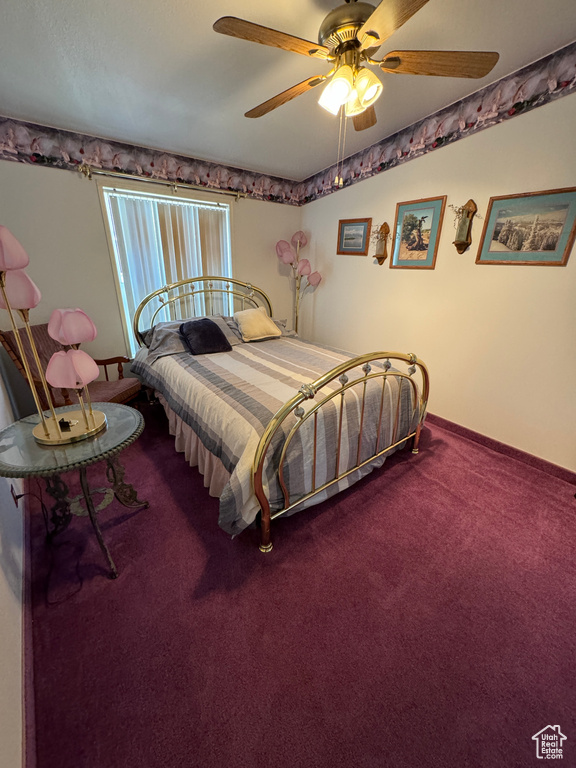 Carpeted bedroom featuring ceiling fan