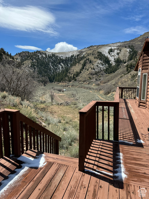 Wooden terrace featuring a mountain view