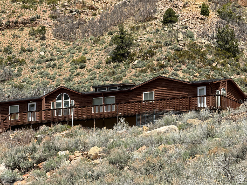 Rear view of house with a wooden deck