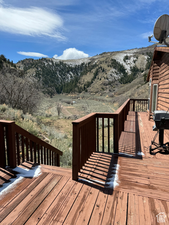 Wooden deck featuring a mountain view