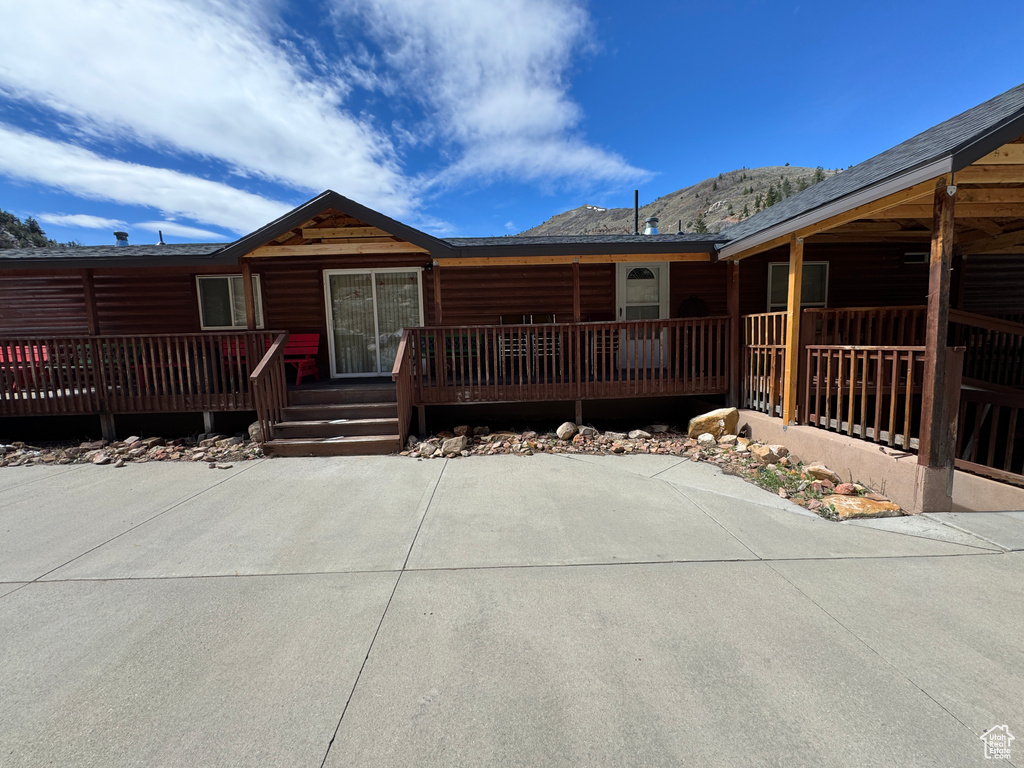 Cabin featuring a deck with mountain view