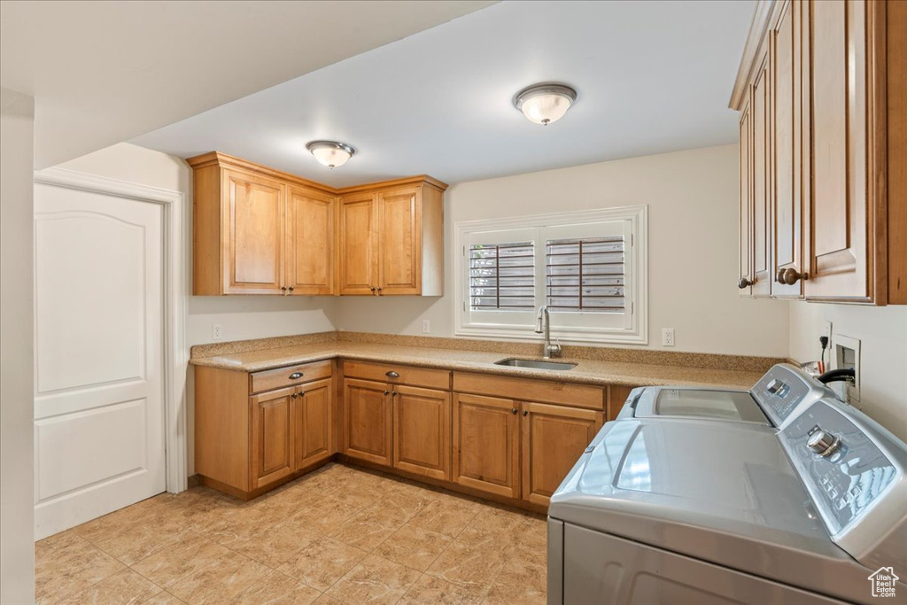 Laundry area with independent washer and dryer, hookup for a washing machine, light tile floors, sink, and cabinets