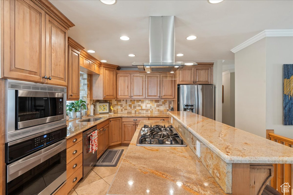 Kitchen with appliances with stainless steel finishes, light tile flooring, tasteful backsplash, ornamental molding, and island exhaust hood