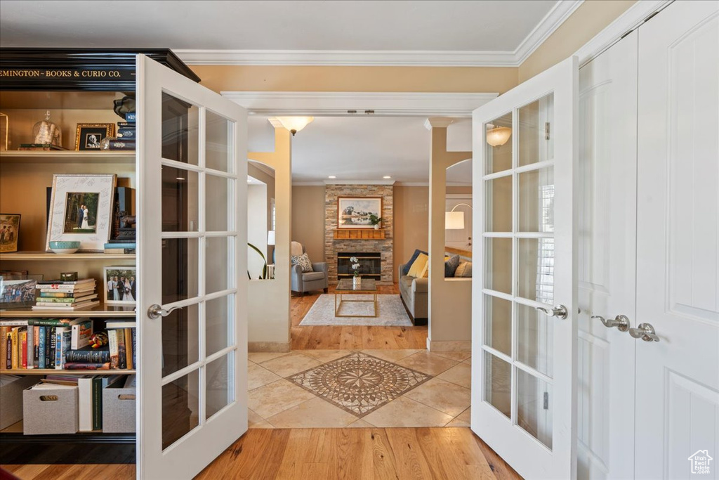 Interior space with french doors, ornamental molding, and wood-type flooring