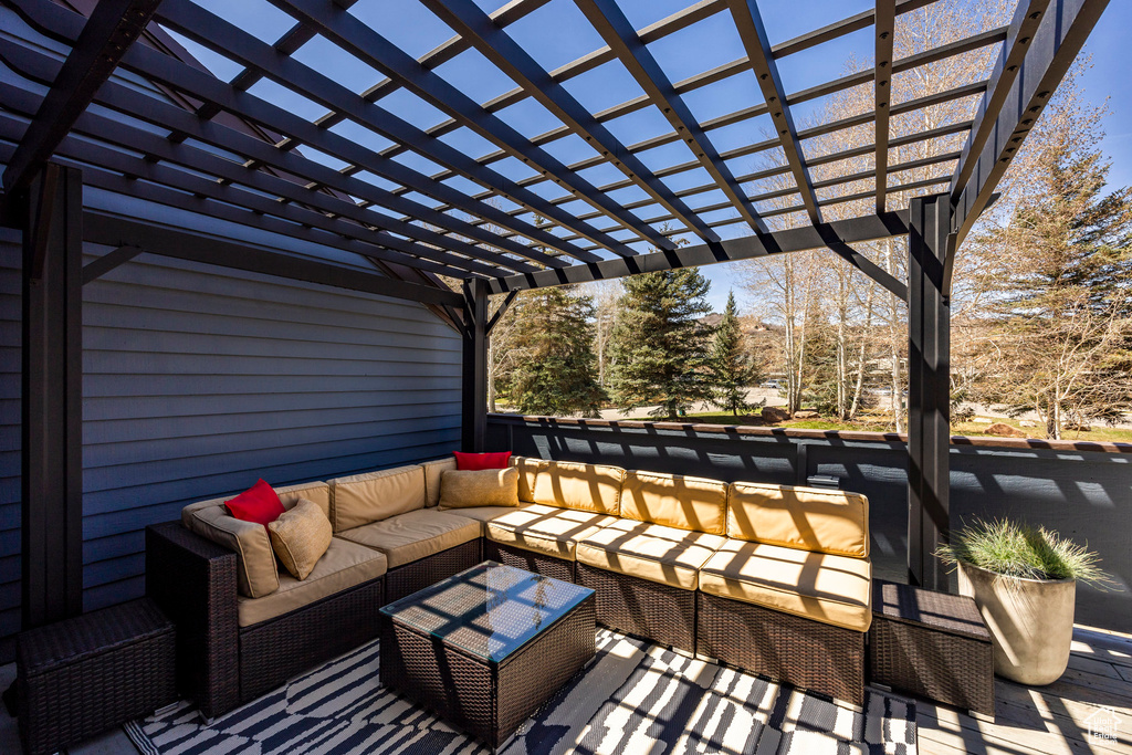 Deck with outdoor lounge area and a pergola