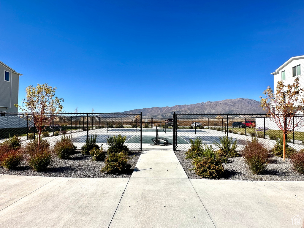 View of home\'s community featuring tennis court and a mountain view