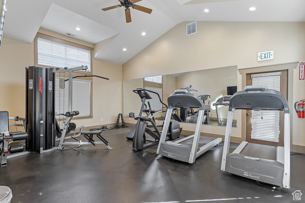 Workout area with high vaulted ceiling and ceiling fan