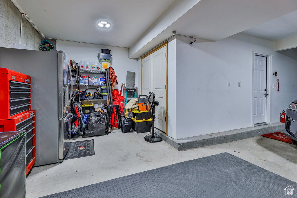 Garage featuring stainless steel fridge