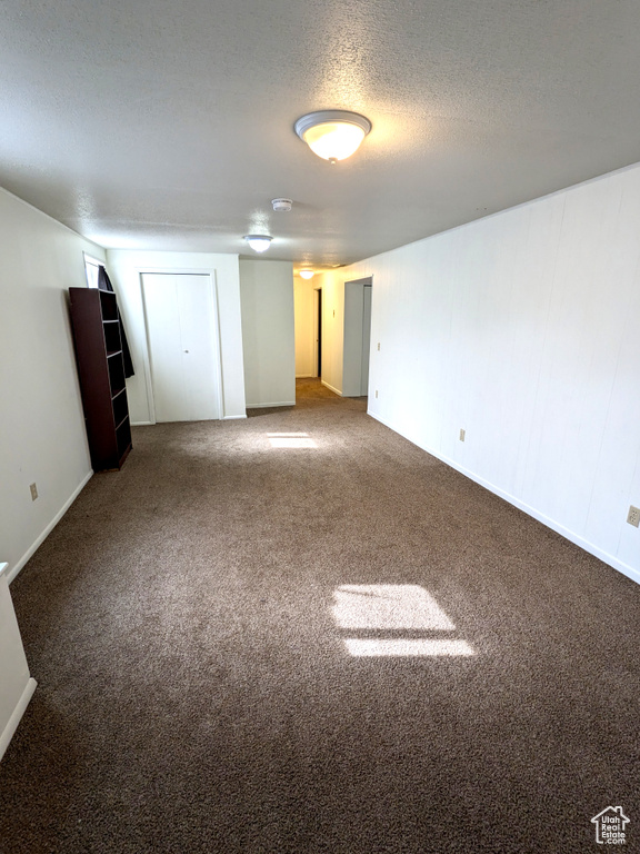 Unfurnished bedroom with carpet flooring and a textured ceiling