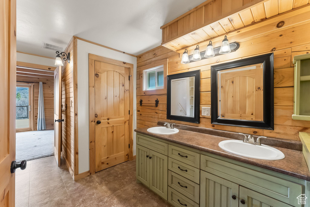 Bathroom featuring tile flooring, wood walls, and double sink vanity