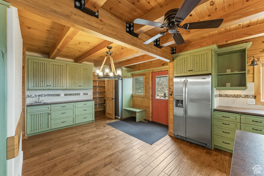 Kitchen with wood ceiling, stainless steel refrigerator with ice dispenser, and wood-type flooring
