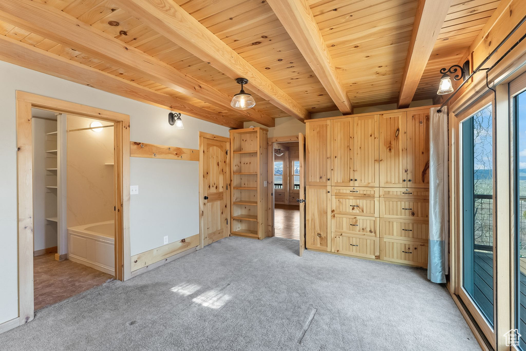 Unfurnished room with wood ceiling, wood walls, light carpet, and beam ceiling