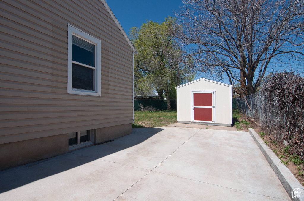 View of patio with a storage unit