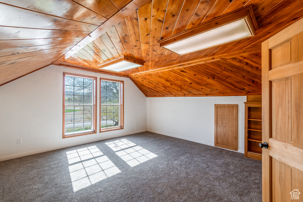 Additional living space with carpet flooring, wooden ceiling, and lofted ceiling