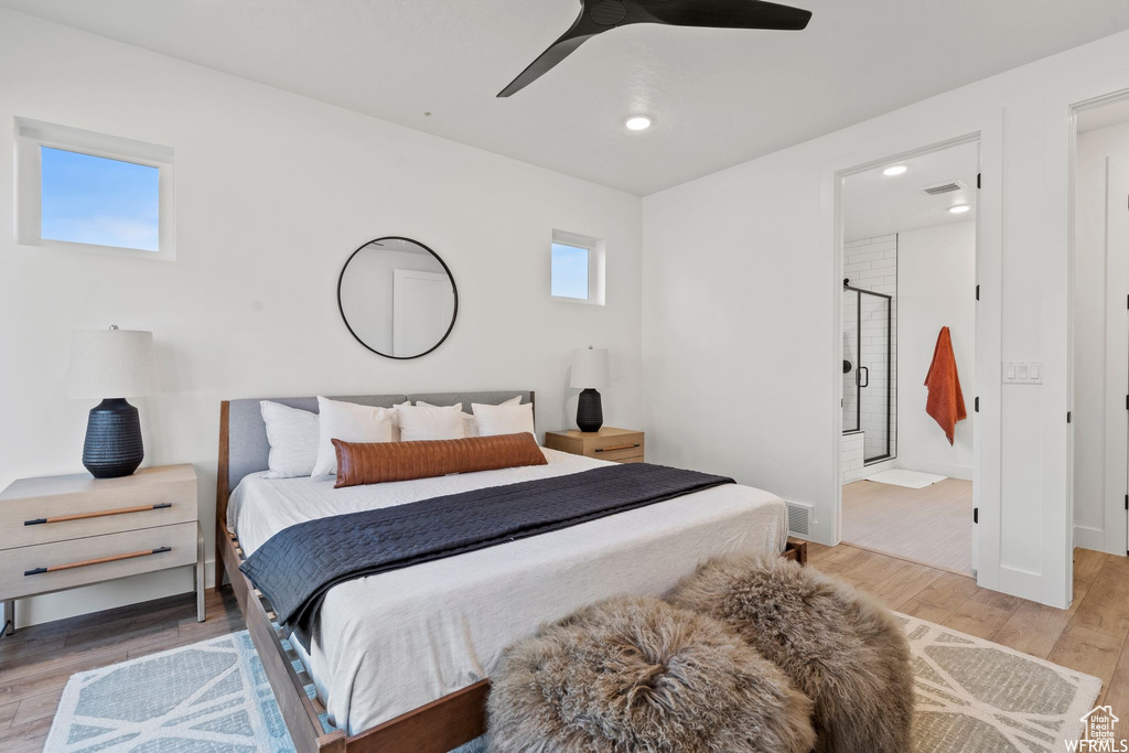 Bedroom featuring light wood-type flooring, ensuite bathroom, and ceiling fan