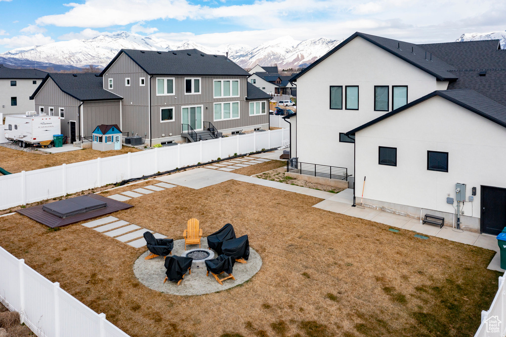 View of yard with a patio area, a mountain view, and an outdoor fire pit