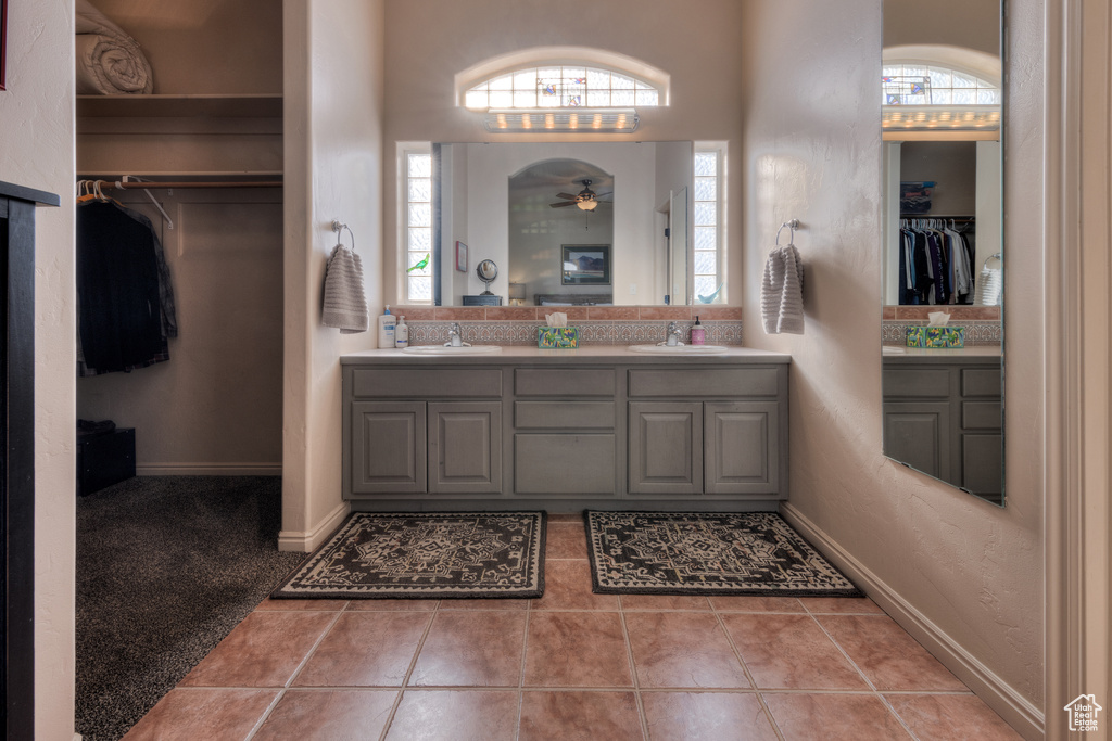 Bathroom featuring plenty of natural light, oversized vanity, tile floors, and double sink