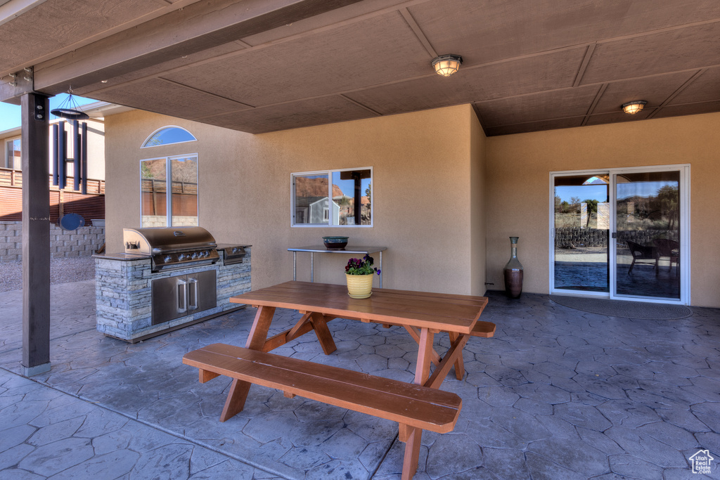View of patio / terrace featuring a grill and an outdoor kitchen