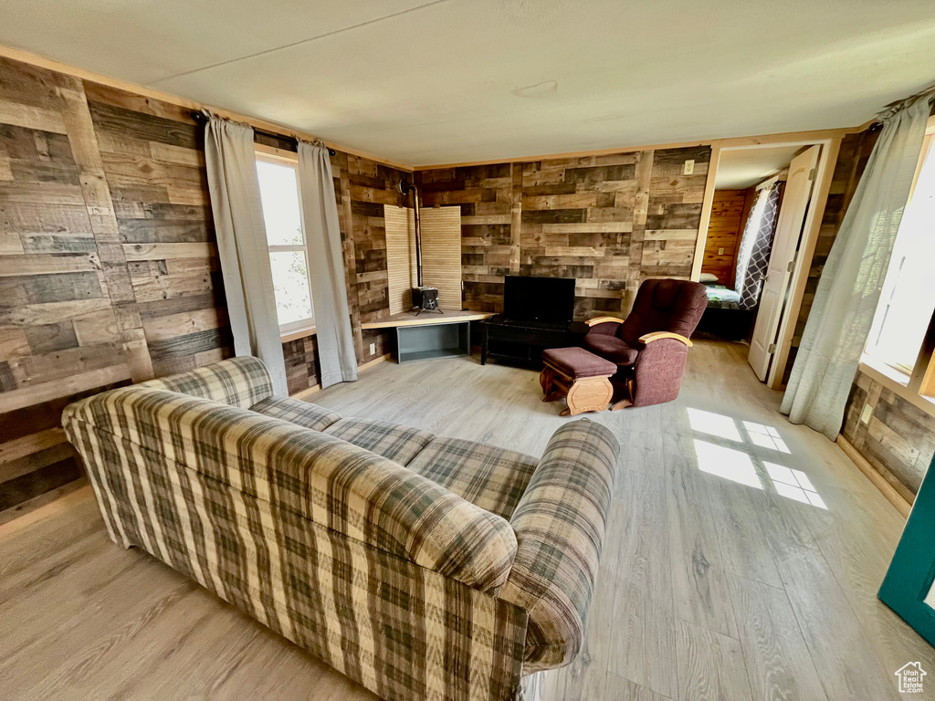 Living room featuring wood walls and light hardwood / wood-style floors
