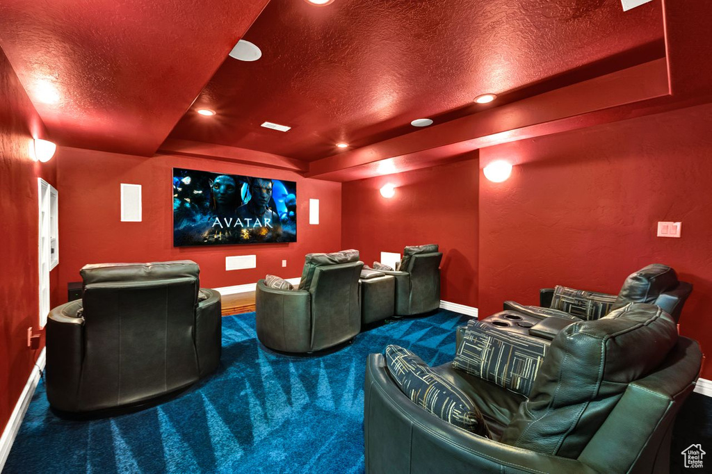 Carpeted home theater room with a textured ceiling