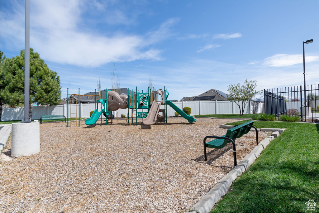 View of jungle gym with a lawn