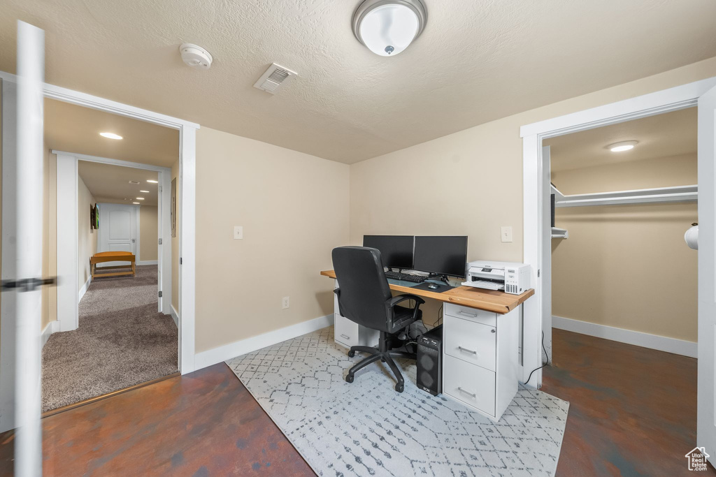 Office featuring carpet and a textured ceiling