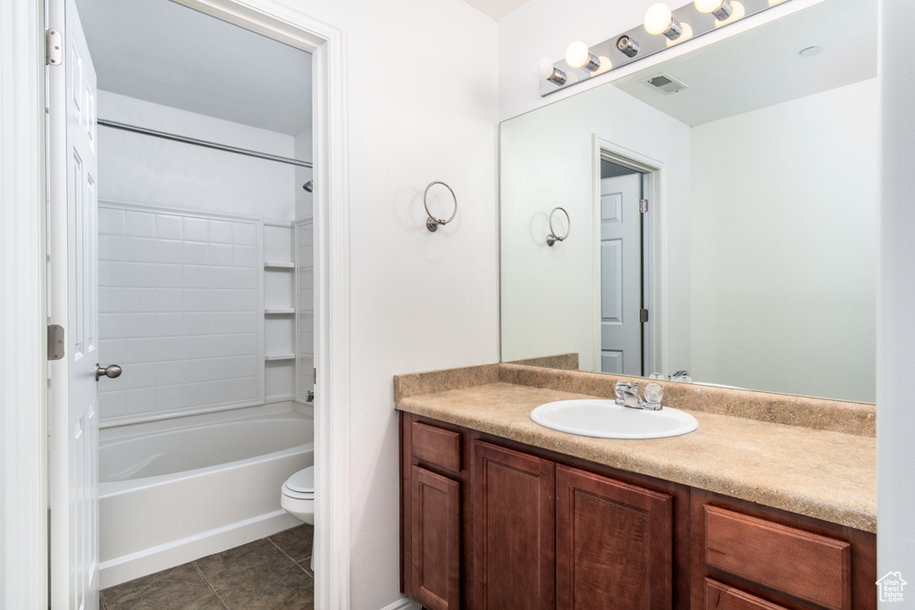 Full bathroom featuring tile flooring, vanity with extensive cabinet space, toilet, and bathing tub / shower combination