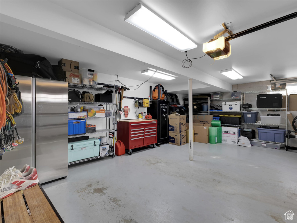 Garage with high quality fridge and a garage door opener