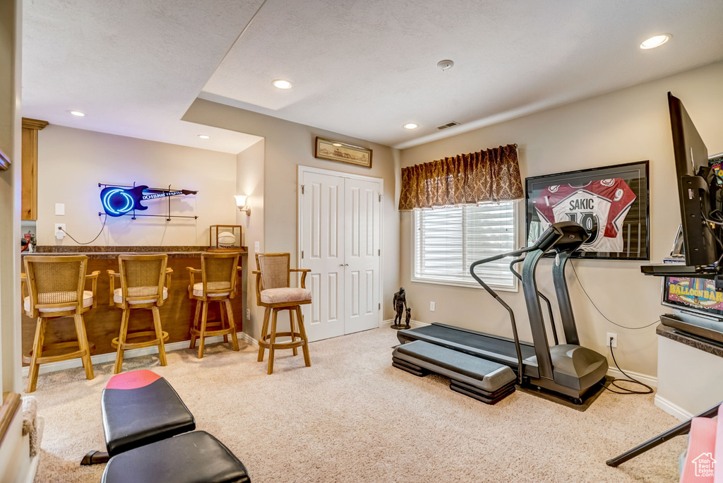 Workout area with bar and light carpet