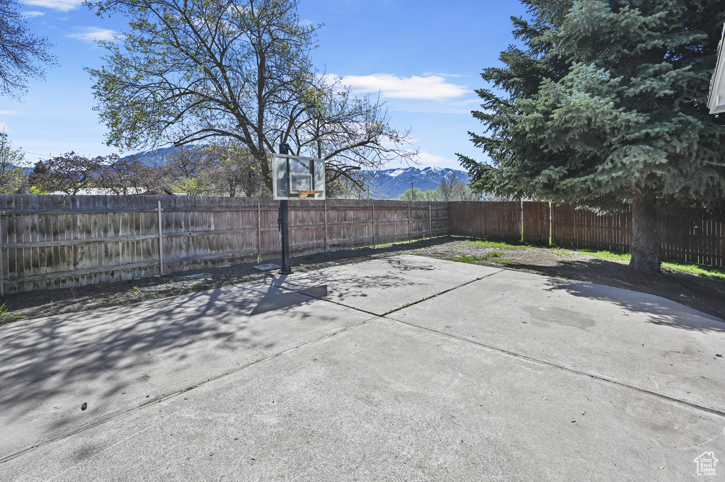 View of patio / terrace featuring basketball hoop and a mountain view