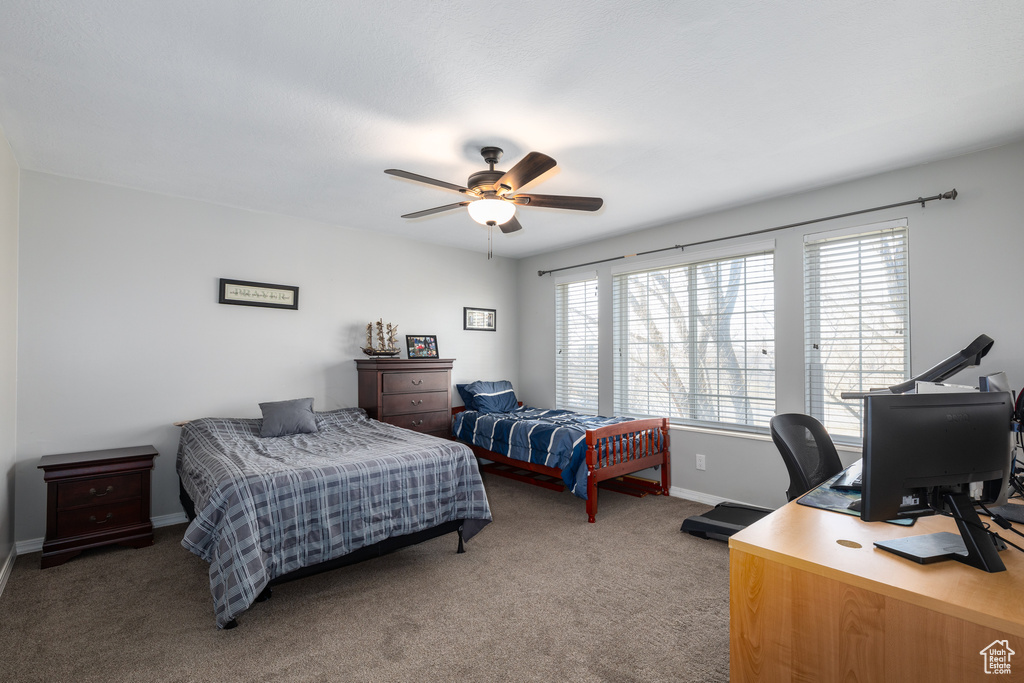 Bedroom featuring dark colored carpet and ceiling fan