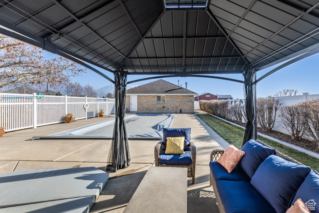 View of patio / terrace featuring an outdoor living space and a gazebo