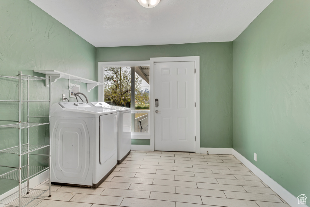 Laundry area with separate washer and dryer, hookup for a washing machine, and light tile floors