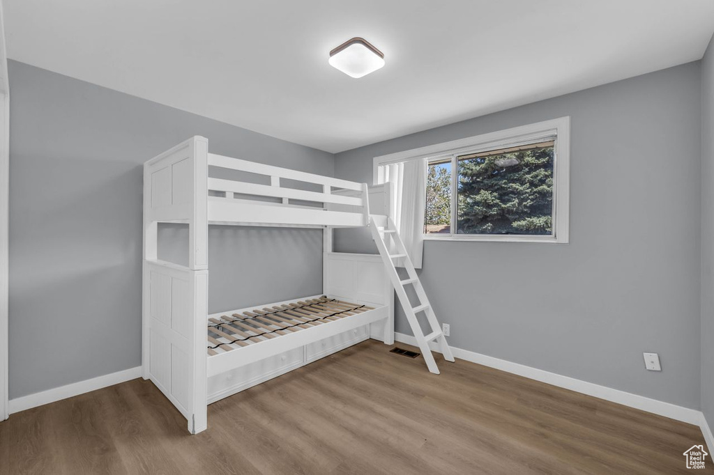Unfurnished bedroom featuring hardwood / wood-style flooring