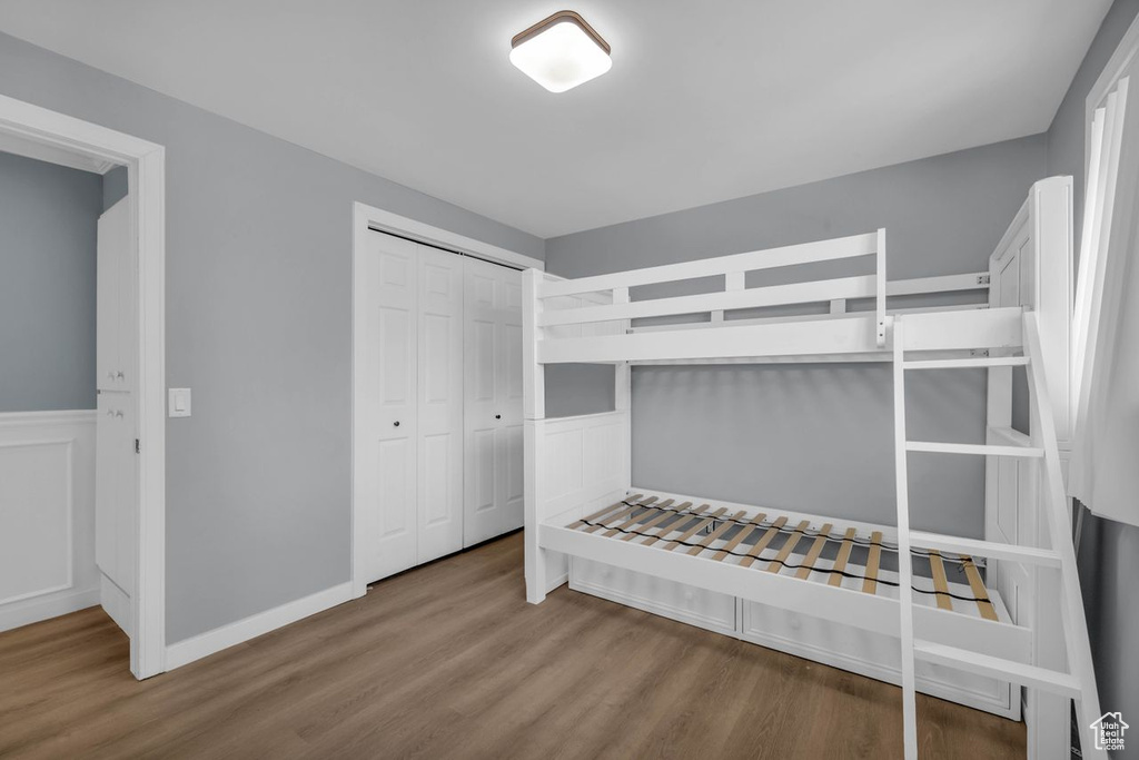 Bedroom with hardwood / wood-style flooring and a closet