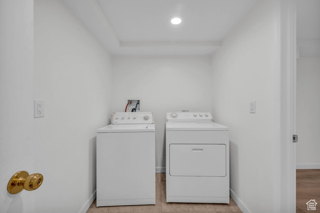 Clothes washing area featuring light hardwood / wood-style floors, independent washer and dryer, and washer hookup