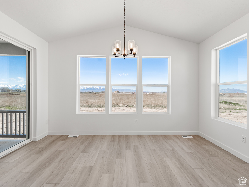 Empty room featuring a healthy amount of sunlight and light hardwood / wood-style floors